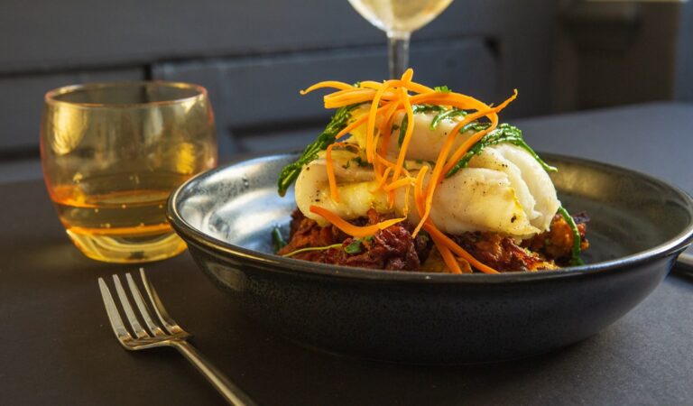 roasted cod curried cauliflower onion bhaji pickled carrot coconut cream wide with table laid 768x450